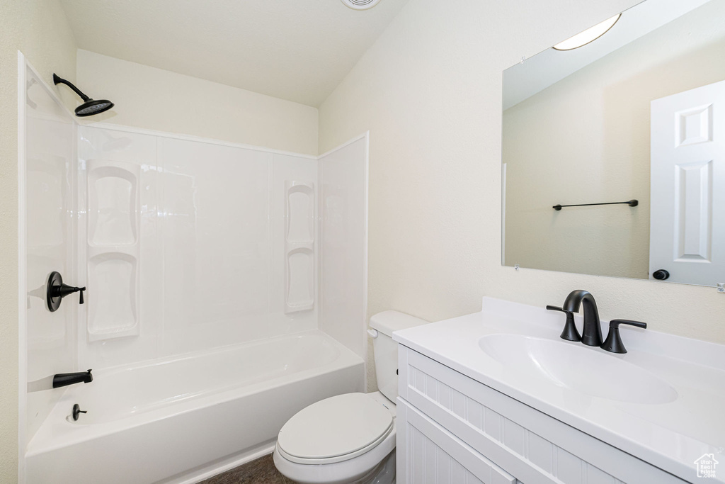 Bathroom featuring vanity, shower / bathing tub combination, and toilet