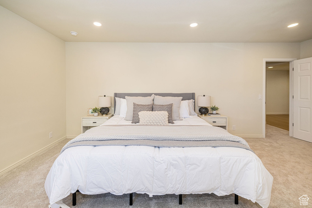 Bedroom with recessed lighting and light carpet