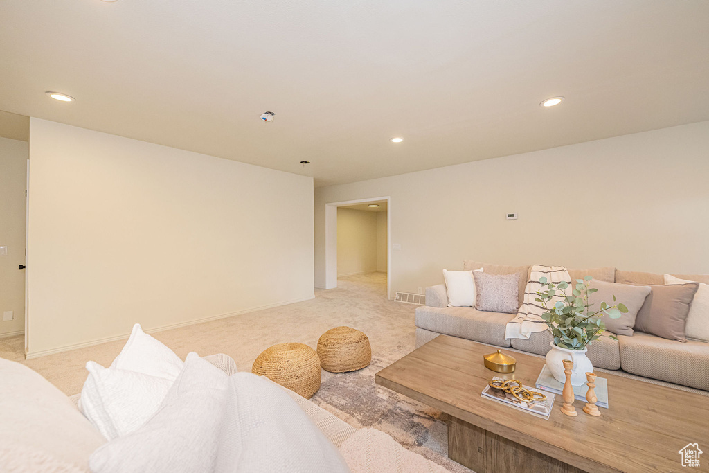 Living room with recessed lighting, baseboards, and light colored carpet