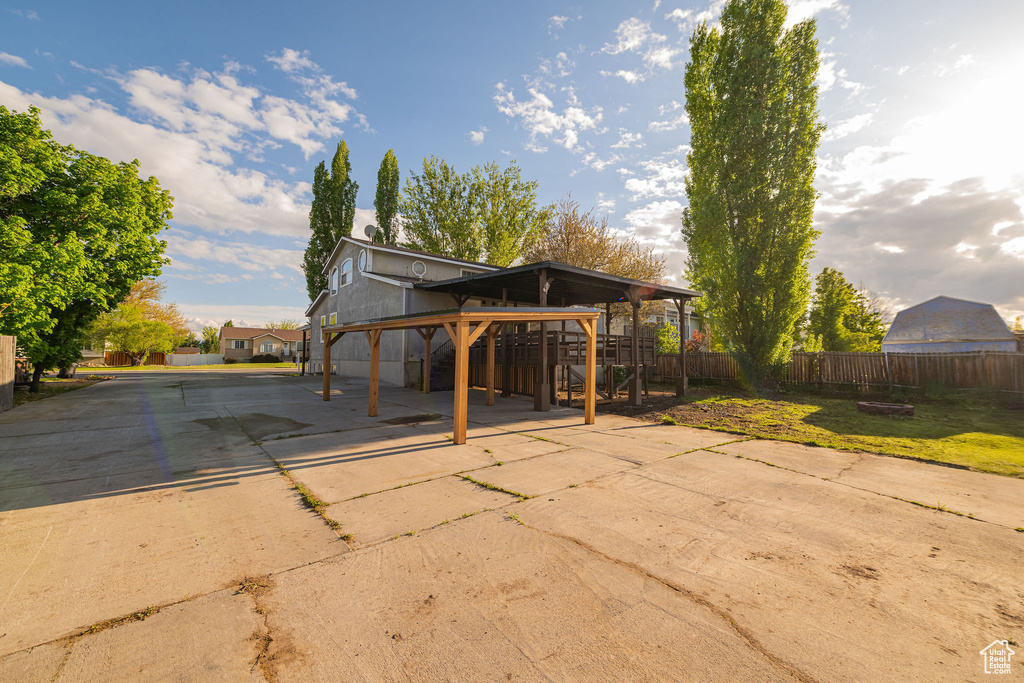 View of patio / terrace with fence and concrete driveway