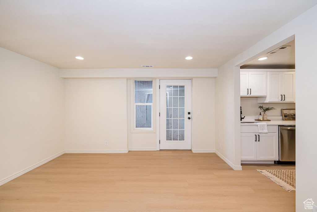 Interior space with light wood-style floors and recessed lighting