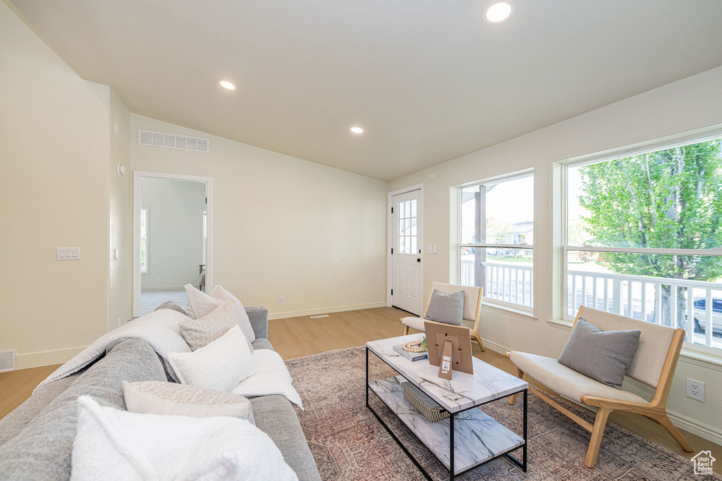 Living room featuring baseboards, visible vents, and a wealth of natural light