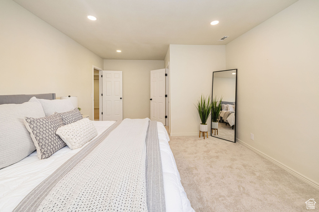 Bedroom with recessed lighting, baseboards, light colored carpet, and visible vents