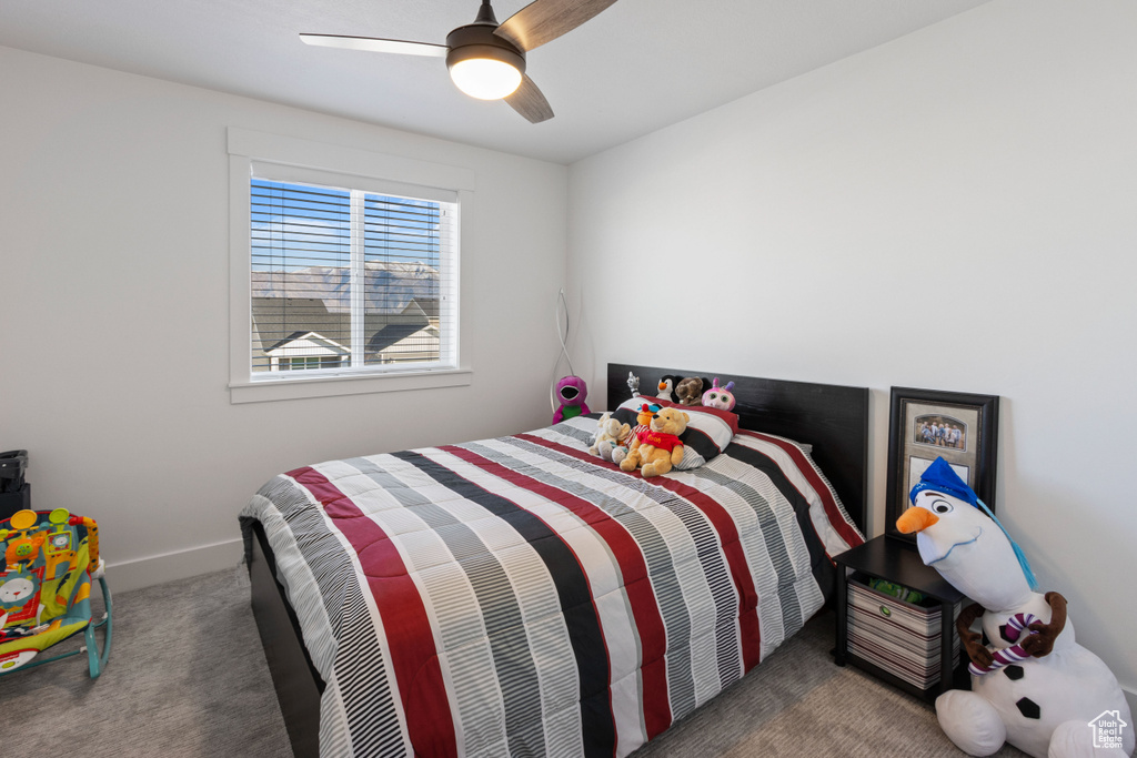 Carpeted bedroom with baseboards and ceiling fan
