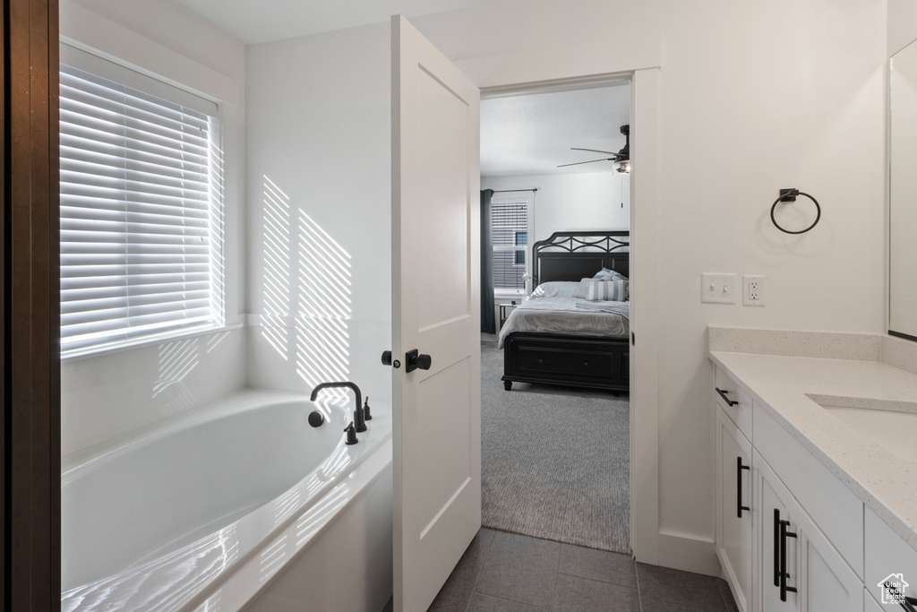Bathroom featuring a ceiling fan, plenty of natural light, and vanity