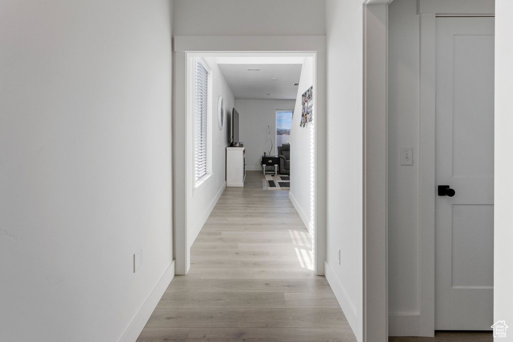 Hall featuring light wood-type flooring and baseboards