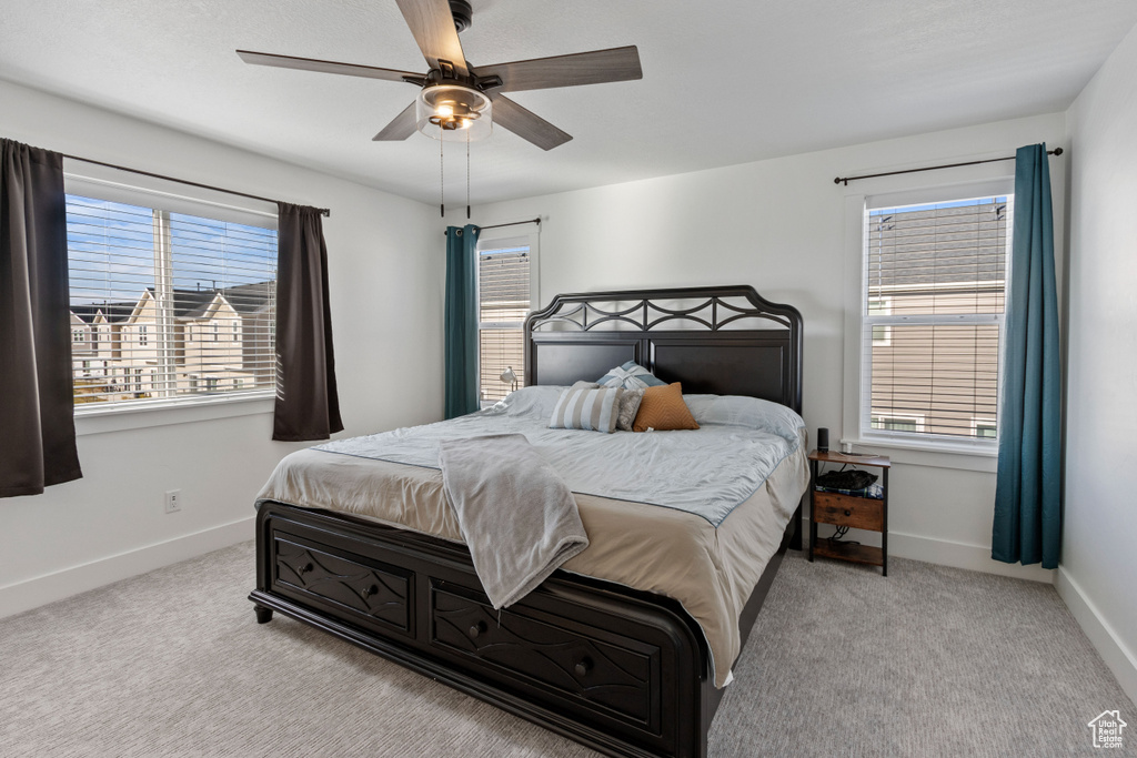 Bedroom with carpet floors, a ceiling fan, and baseboards
