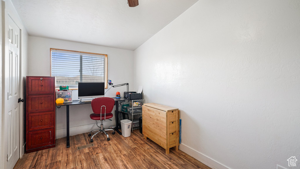 Office space featuring wood finished floors and baseboards