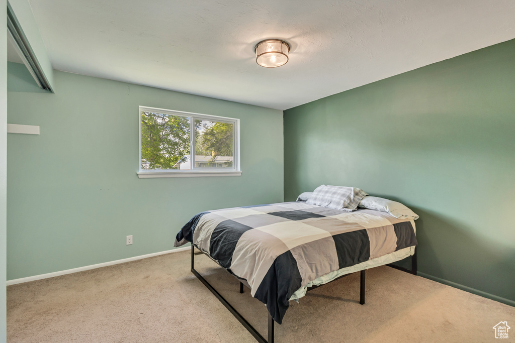 Carpeted bedroom featuring baseboards