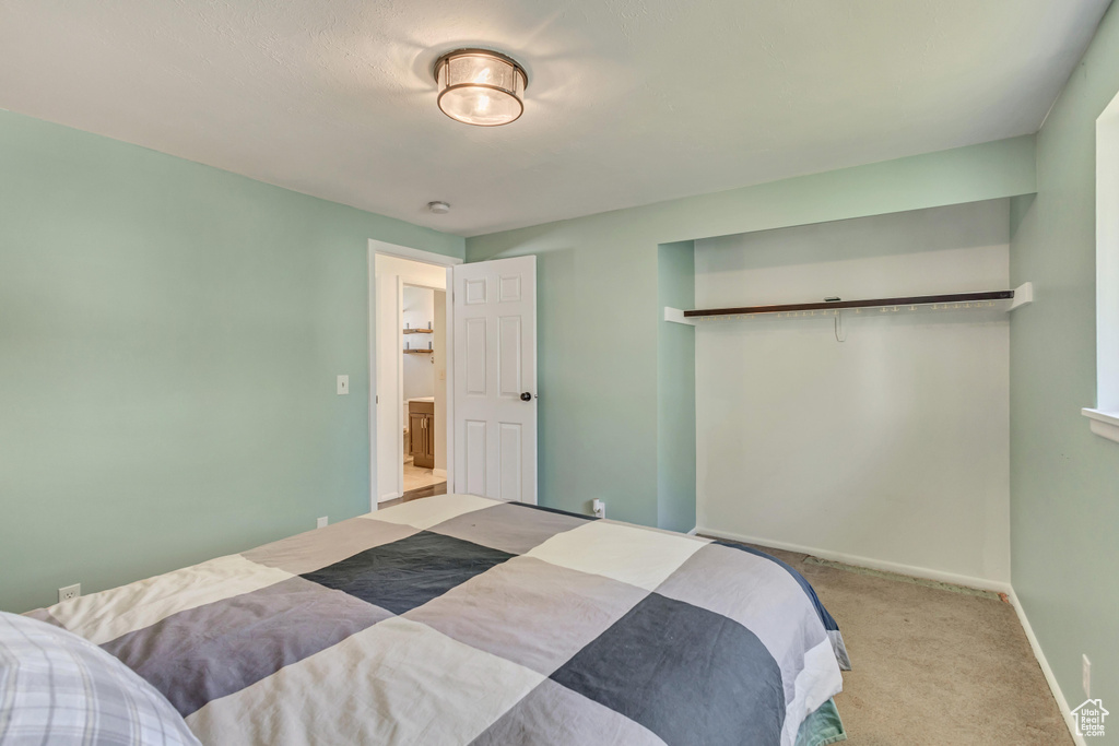 Bedroom with carpet floors and baseboards