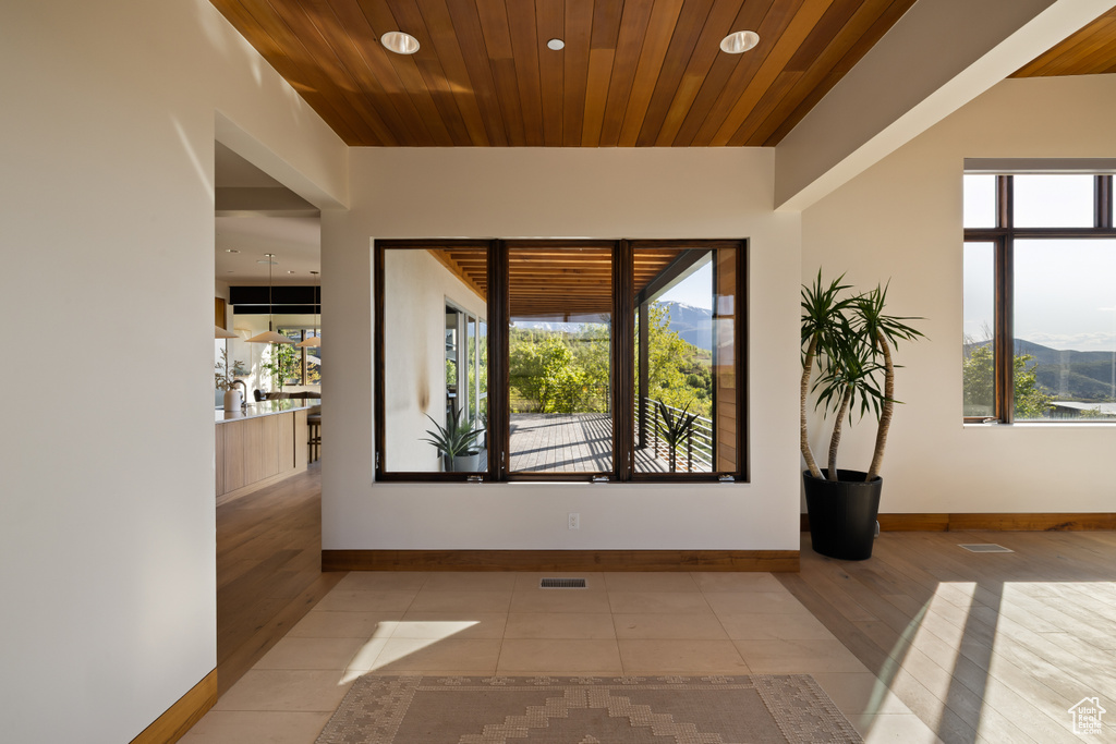 Empty room featuring wood finished floors, baseboards, recessed lighting, and wood ceiling