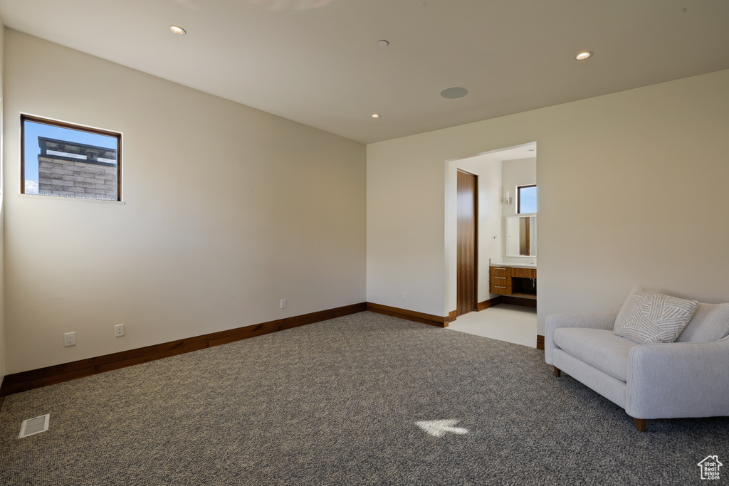 Unfurnished living room with carpet, baseboards, and recessed lighting