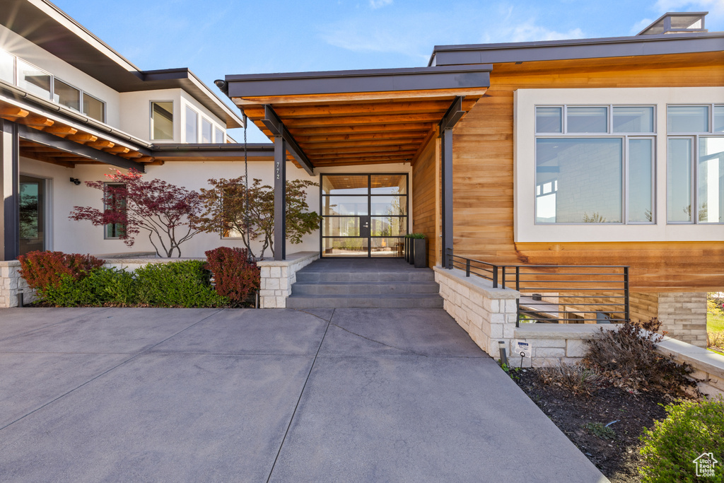 Entrance to property with stucco siding