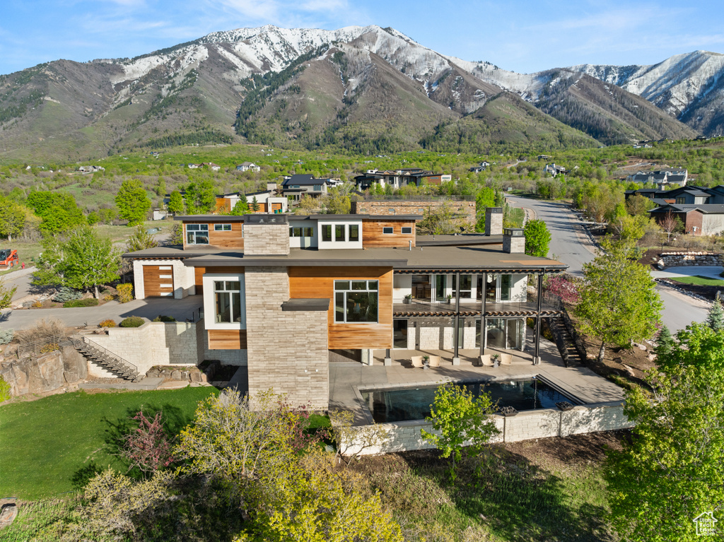 Rear view of house with stairway and a mountain view