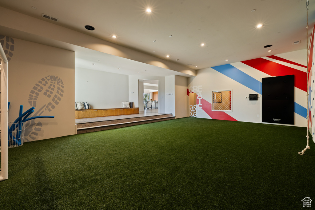 Rec room with carpet floors, recessed lighting, a putting area, and golf simulator