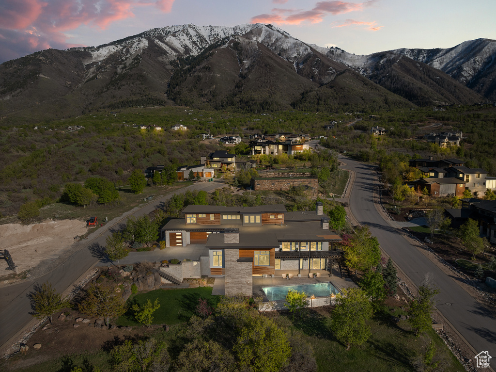 Aerial view of property's location featuring a mountainous background
