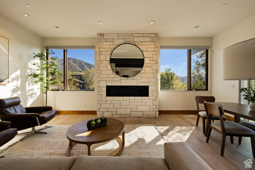 Living area featuring baseboards, plenty of natural light, wood finished floors, and recessed lighting