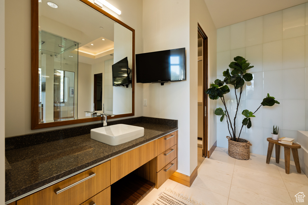 Bathroom with tile patterned floors, recessed lighting, vanity, and a shower with door