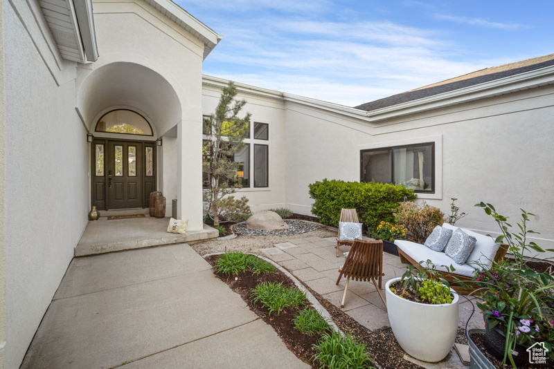 Entrance to property with stucco siding