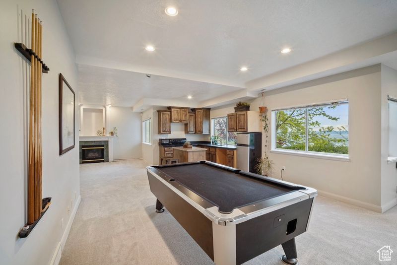 Playroom featuring light carpet, a tiled fireplace, recessed lighting, baseboards, and billiards