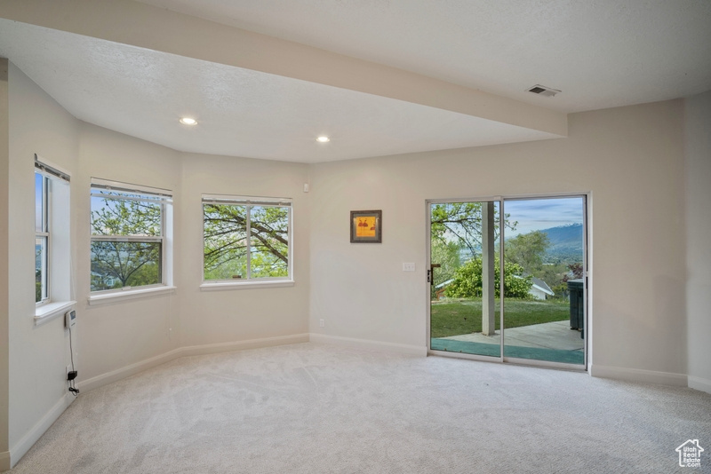 Unfurnished room with baseboards, recessed lighting, visible vents, and light carpet