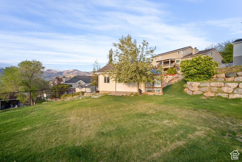 View of yard with fence and a mountain view