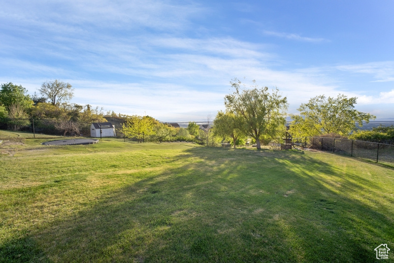 View of yard featuring fence