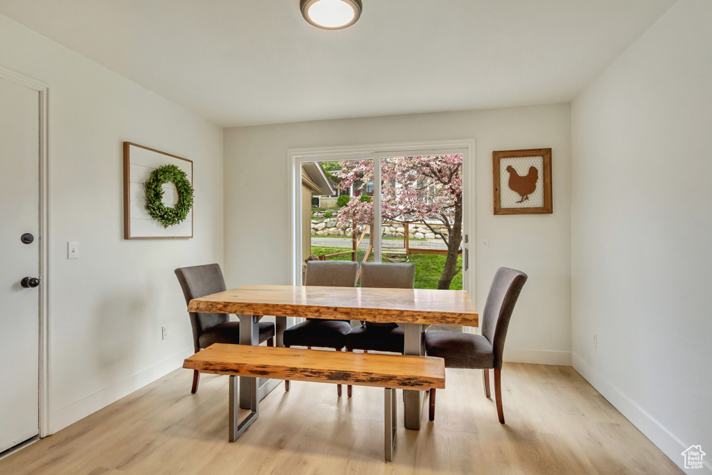 Dining space featuring baseboards and light wood finished floors