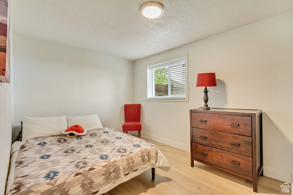 Bedroom with baseboards and light wood-style floors