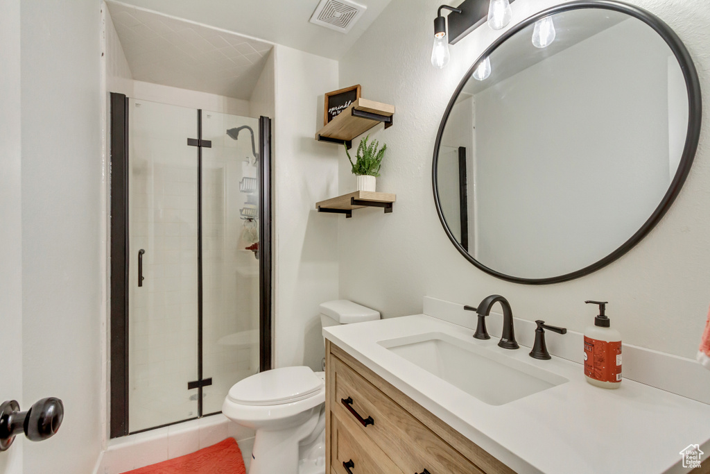 Full bath featuring tile patterned flooring, a stall shower, toilet, and visible vents