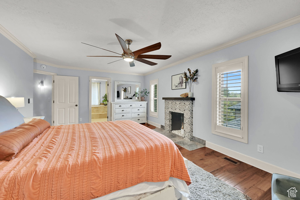 Bedroom with visible vents, crown molding, and wood finished floors