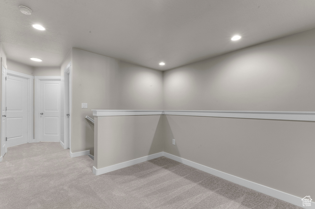 Below grade area with recessed lighting, baseboards, and light carpet