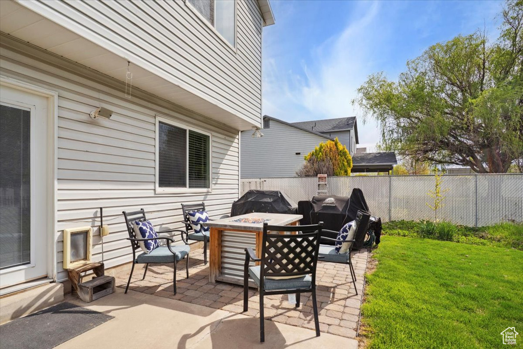 View of patio / terrace with a fenced backyard, grilling area, and a fire pit