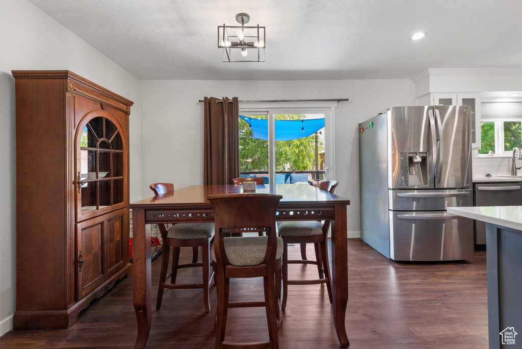 Dining room featuring recessed lighting, baseboards, dark wood-style floors, and a wealth of natural light