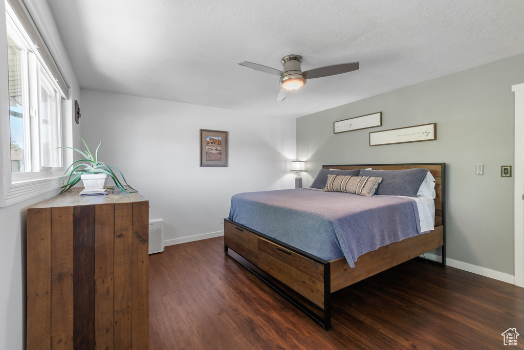 Bedroom with baseboards, a ceiling fan, and dark wood finished floors