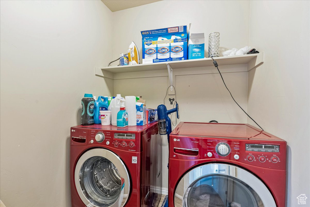 Laundry area featuring separate washer and dryer and laundry area