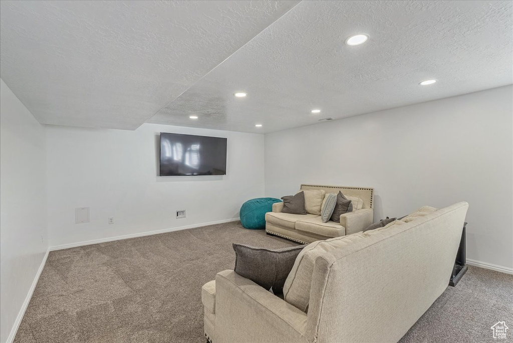 Living room featuring recessed lighting, baseboards, and carpet