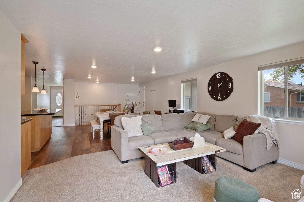Living room with baseboards, recessed lighting, and wood finished floors