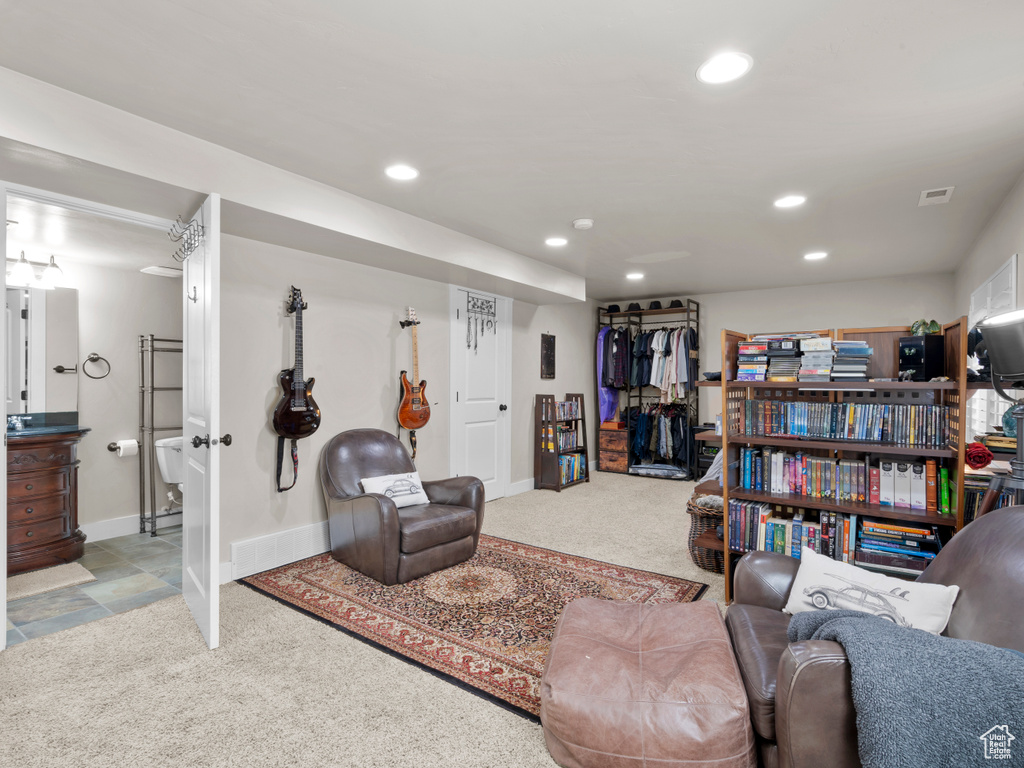 Carpeted living room with baseboards, visible vents, and recessed lighting