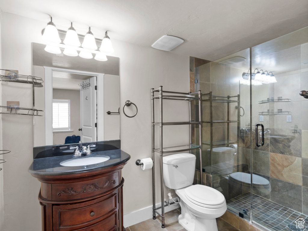 Bathroom with baseboards, a shower stall, toilet, and vanity