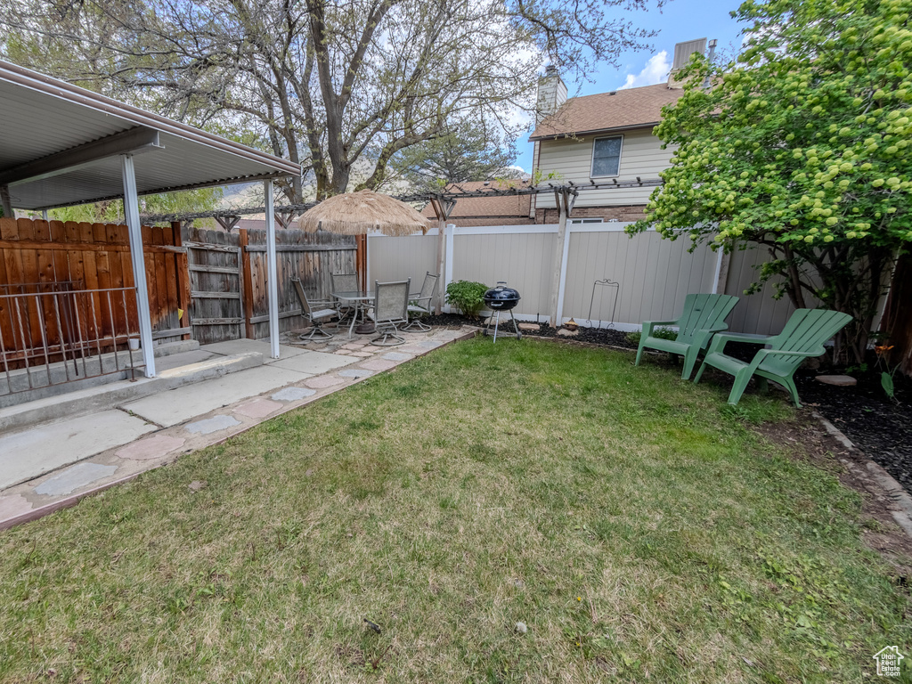 View of yard with a fenced backyard and a patio area