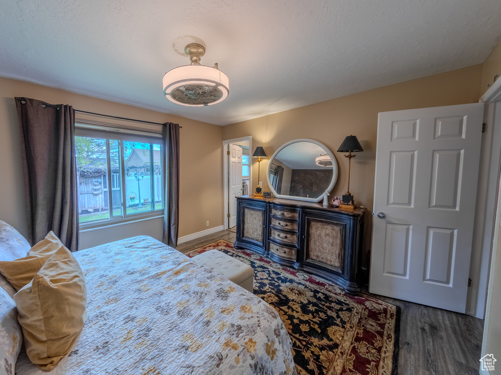 Bedroom featuring baseboards and wood finished floors
