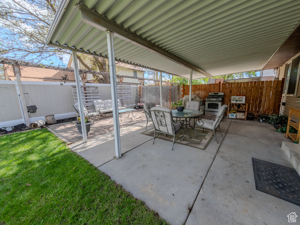 View of patio with a fenced backyard and outdoor dining space