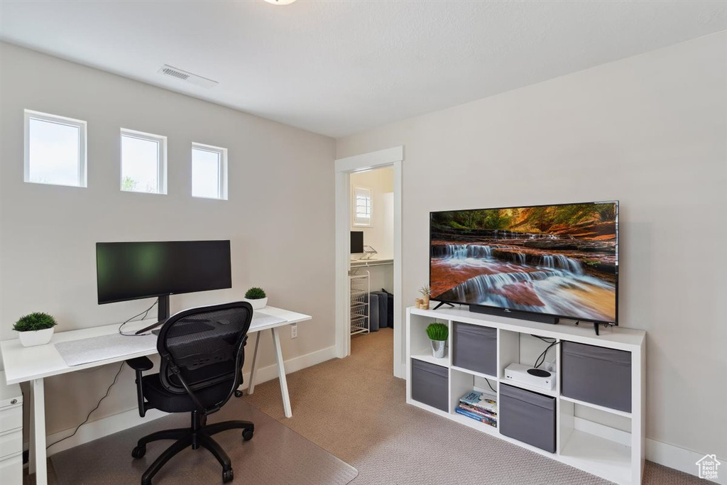 Carpeted office featuring visible vents and baseboards
