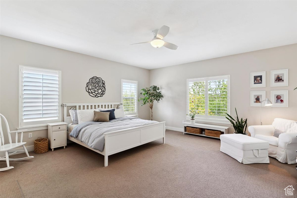 Bedroom featuring baseboards, a ceiling fan, and carpet flooring
