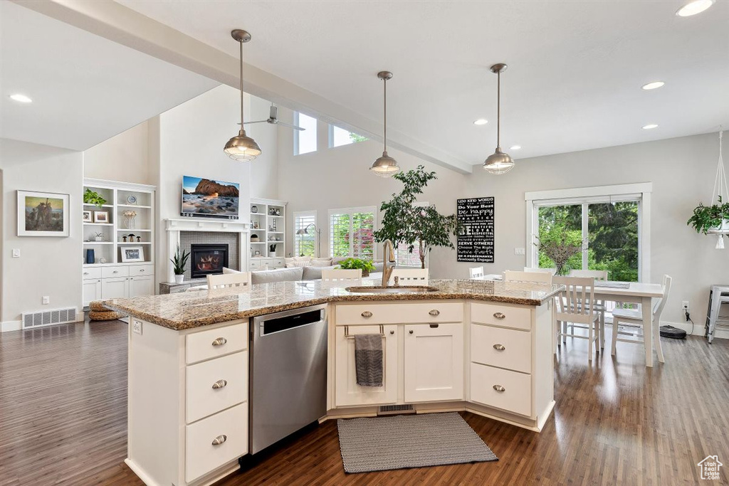 Kitchen featuring visible vents, open floor plan, dark wood-style floors, a sink, and dishwasher