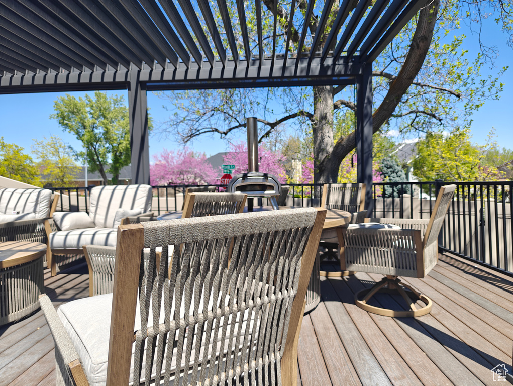Wooden deck featuring a pergola and outdoor lounge area