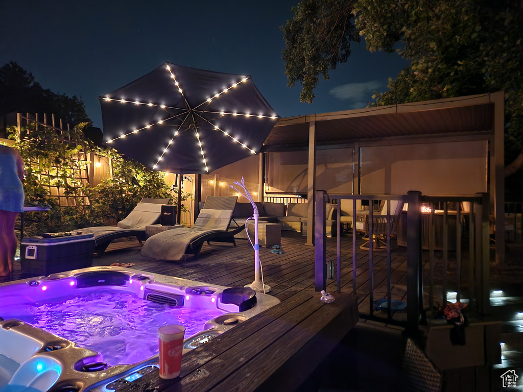 Deck at twilight with hot tub deck surround