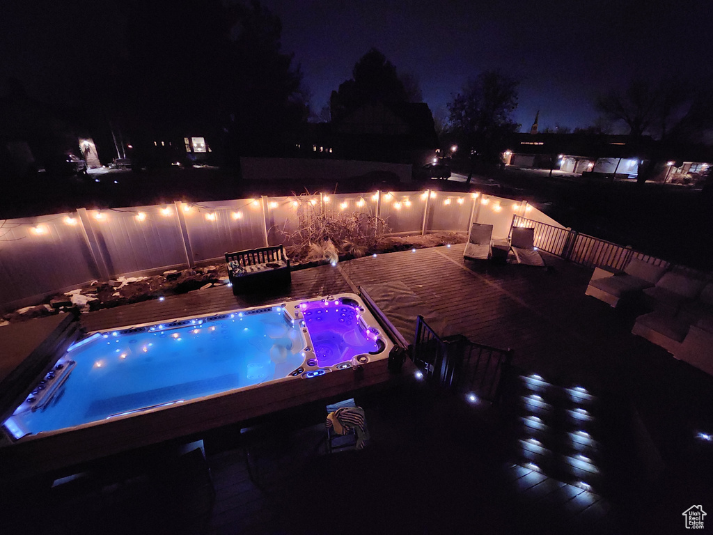 Pool at twilight with a hot tub