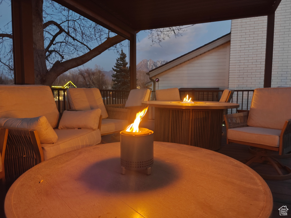 View of patio featuring an outdoor living space with a fire pit and a mountain view